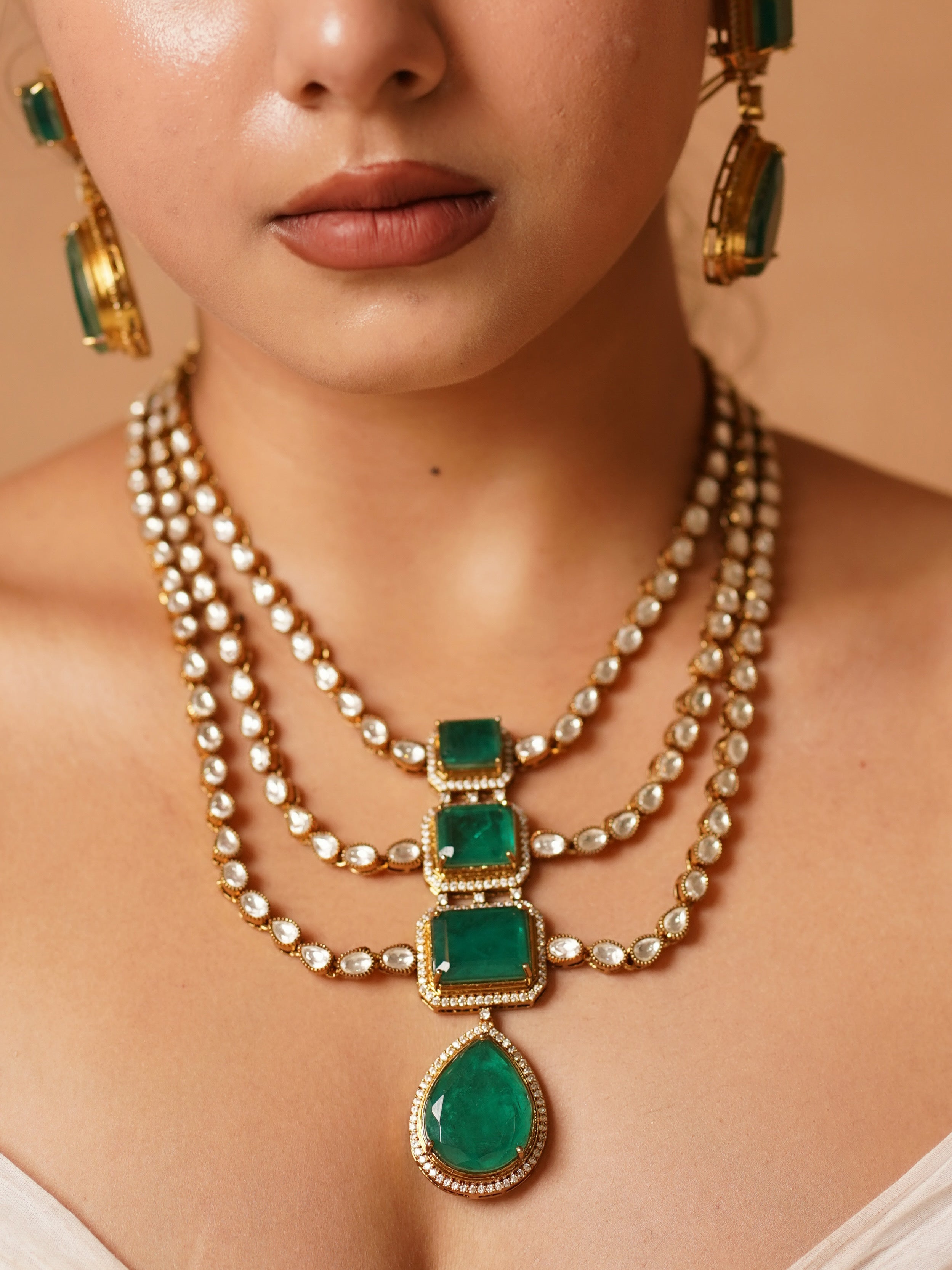 Side view of emerald Victorian necklace with matching earrings and floral design